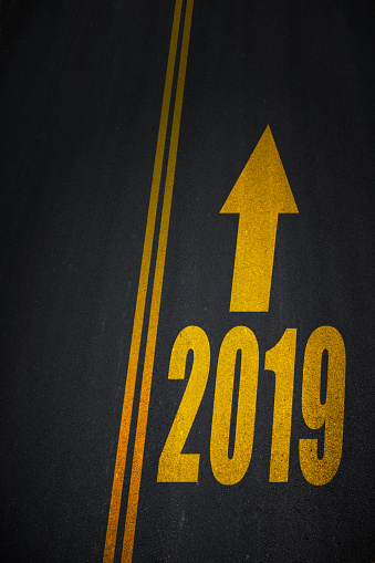 New year 2019 text with arrow sign on asphalt road.