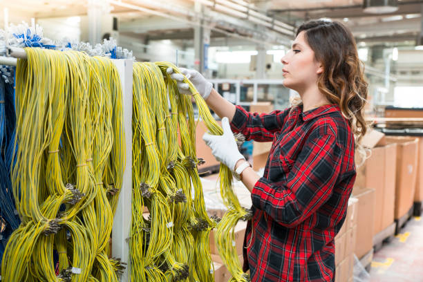 istock Young female working in cable factory 1047313670