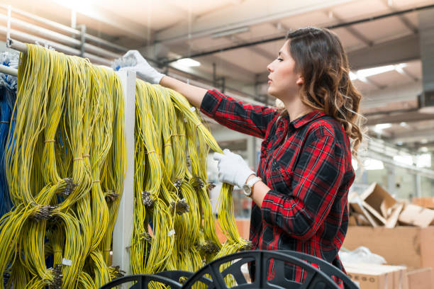 istock Young female working in cable factory 1047313968