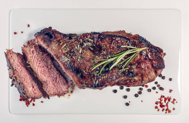 istock Sliced grilled beef steak on the white plate 1047316118