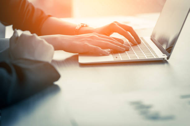 istock closeup businessman hand working with laptop with blur background 1047319244