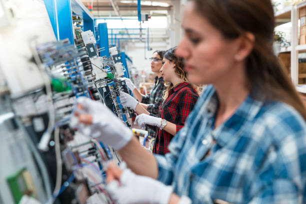 women working in cable factory - electric plug electricity women power imagens e fotografias de stock