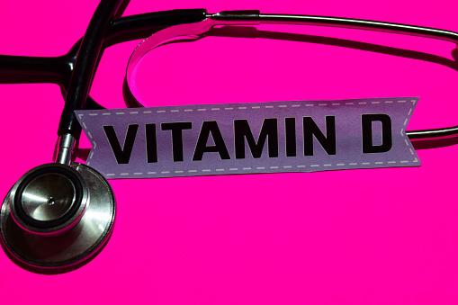 Vitamin D on the paper with medicare Concept Inspiration. Stethoscope on pink bakcground