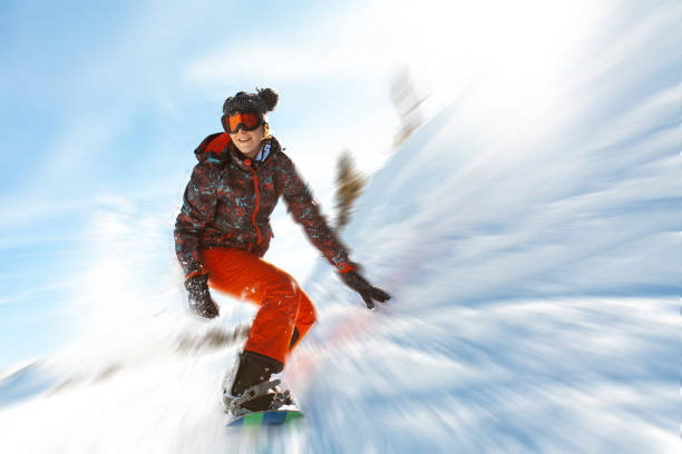 istock Female snowboarder having fun on ski track 1047330162