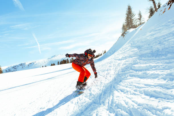istock Female snowboarder having fun on ski track 1047330194