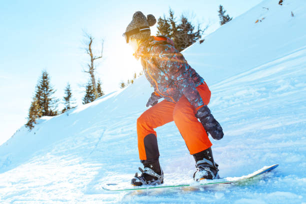 istock Female snowboarder having fun on ski track 1047330198