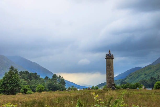 Glenfinnan Monument, Highland, Scotland. Glenfinnan, Lochaber, Scotland, UK - August 2, 2016: Glenfinnan Monument at Loch Shiel, scottish Highlands. Memorial of the Jacobite rising in 1745. glenfinnan monument stock pictures, royalty-free photos & images