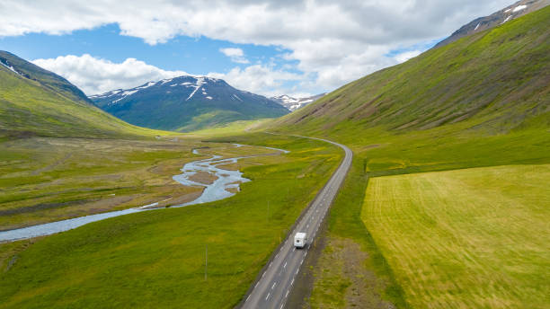 aerial view of motorhome on the road in iceland, road trip at summertime. - winding road sunlight field cultivated land imagens e fotografias de stock