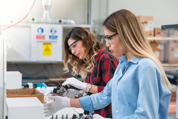 women working in cable factory - electric plug electricity women power imagens e fotografias de stock