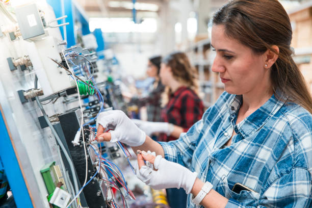 women working in cable factory - electric plug electricity women power imagens e fotografias de stock