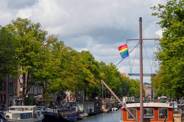 istock Rainbow Pride Flag on Boat In Amsterdam Canal 1047342432