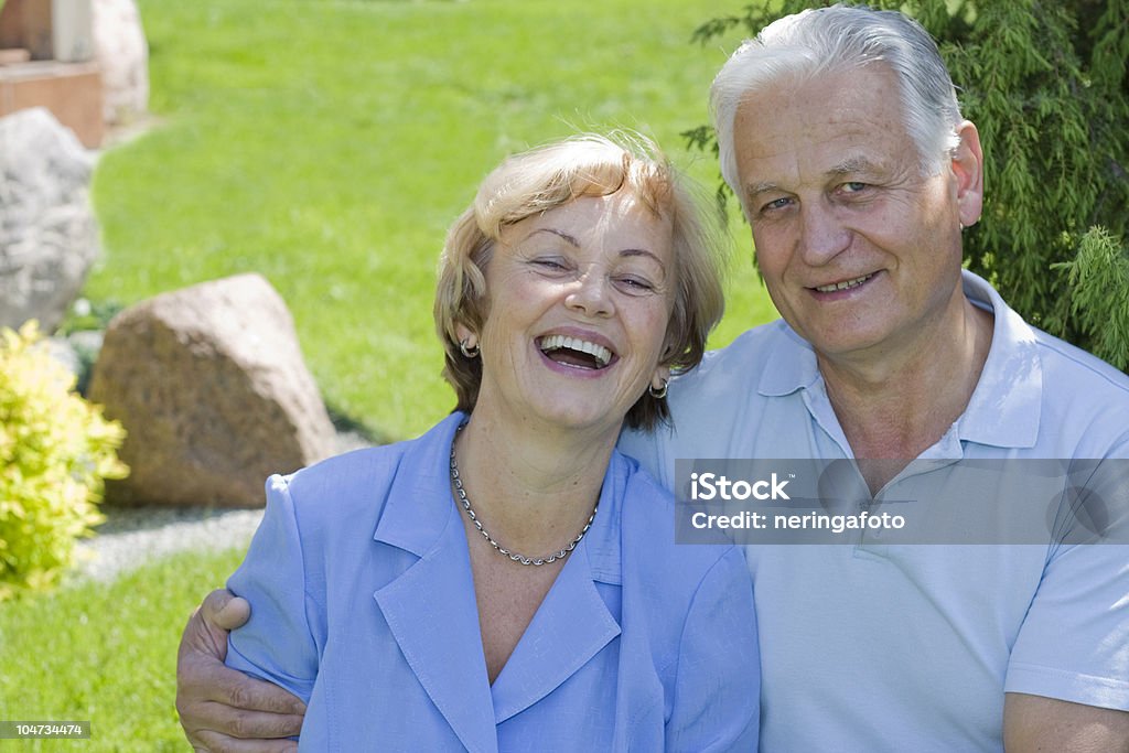 Smiling senior couple in the backyard http://www.istockphoto.com/file_thumbview_approve/13089522  60-69 Years Stock Photo