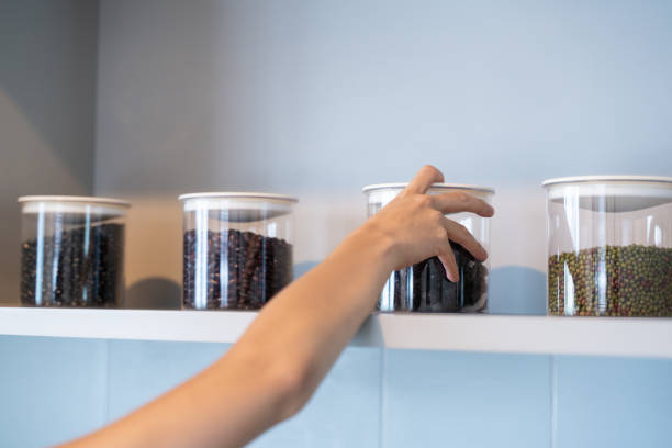 istock Hand Hold Bottle Of dry plum in kitchen 1047356548
