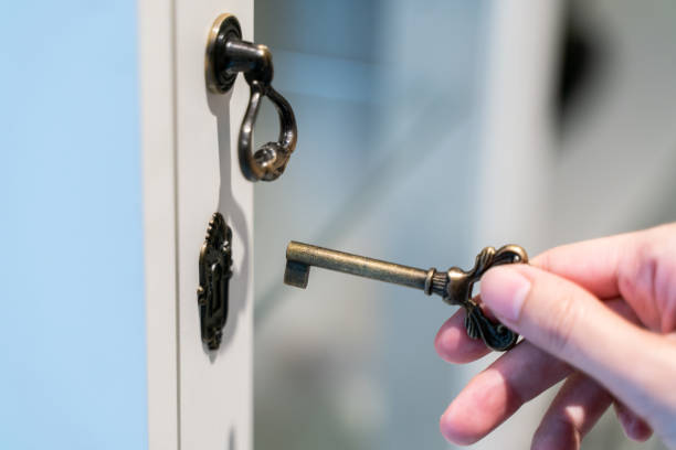 istock Hand holding metal vintage key to unlock. 1047364034