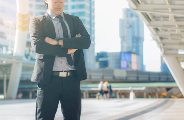istock businessman stands in city. 1047369576