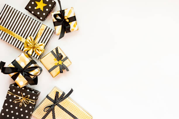 istock Top view of gift boxes in various black, white and golden designs. Flat lay, copy space. A concept of Christmas, New Year, birthday celebration event. 1047374756