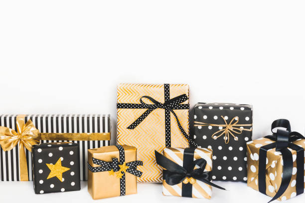 istock Front view of gift boxes in various black, white and golden designs. Copy space. A concept of Christmas, New Year, birthday celebration event. 1047374796