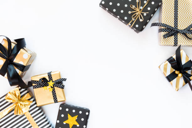 istock Top view of gift boxes in various black, white and golden designs. Flat lay, copy space. A concept of Christmas, New Year, birthday celebration event. 1047374814