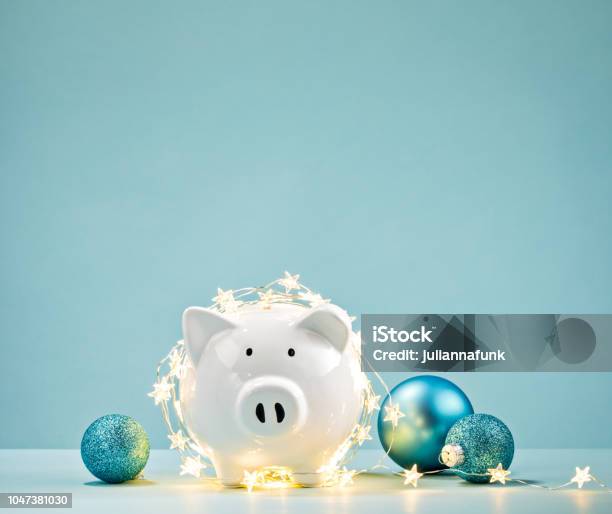 Piggy Bank Wrapped In A String Of Christmas Lights Stock Photo - Download Image Now - Christmas, Holiday - Event, Budget
