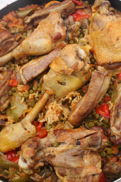 istock Paella with chicken lamb meat and seafood 1047383348