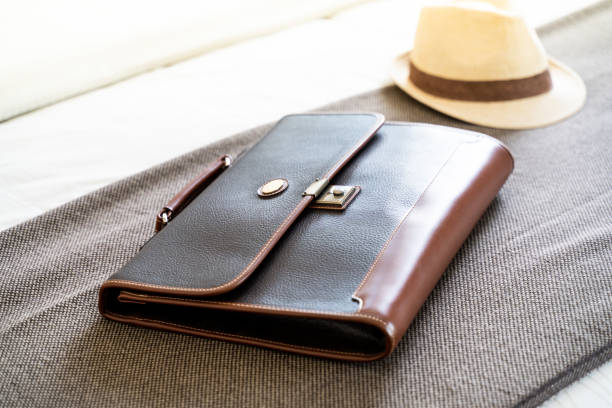 istock vintage dark leather handbag on brown and Hat weave background 1047389266