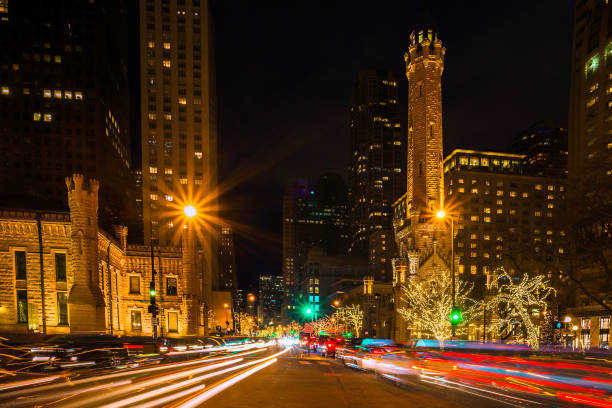 Chicago's Michigan Avenue at Christmas Long exposure of traffic trails along Michigan Avenue in Chicago at Christmastime.  The landmark old Water Tower is seen. michigan avenue chicago stock pictures, royalty-free photos & images