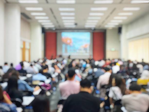 istock Blurred image of large examination room with students sitting on lecture chair doing final exam, studying, learning, doing final test in exam hall in university or campus. Education concept. 1047401296