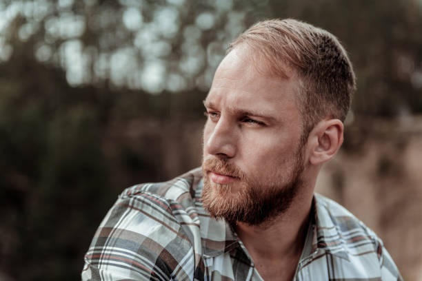 istock Close up of handsome bearded blonde-haired man feeling rather serious 1047407232