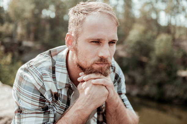 istock Blonde-haired man feeling unsure about making serious life changing decision 1047407264