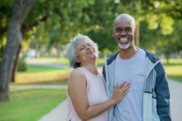 istock Happy senior couple laughing while exercising in park 1047407428