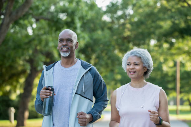 istock Active senior couple jogging outdoors together 1047407452