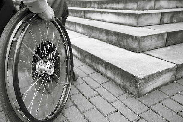 istock Wheelchair user in front of staircase Barrier (XXL) 104740854