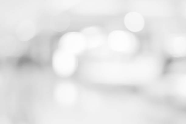 istock Abstract blurred soft white and gray silver beautiful of interior workplace with glowing bokeh background for merry christmas and happy new year design banner  and presentation concept 1047409932