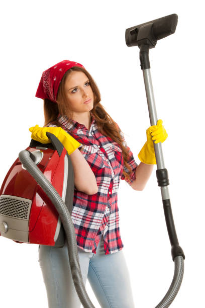 istock Sad woman works with vacuum cleaner isolated over white background 1047410190