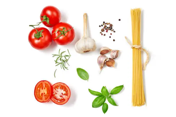 Photo of Spaghetti with tomatoes garlic and basil isolated on white background. Top view.