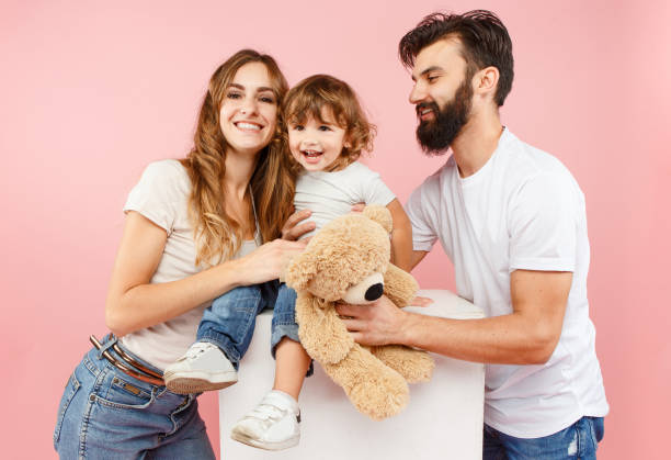istock A happy family on pink background 1047416214