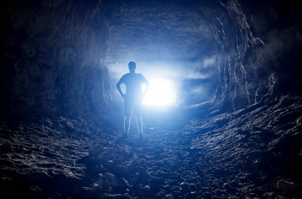 istock Silhouette of a man in a cave 1047416610