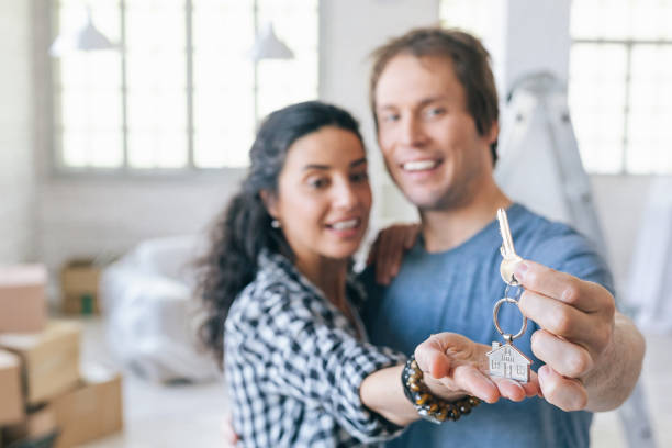 istock Couple cheerful home owners holding a key 1047425084
