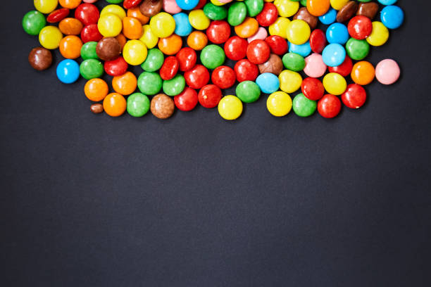 istock Small colorful candy on a black background. 1047433506