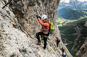 four mountain climbers on a Via Ferrata in the Dolomites in Alta Badia
