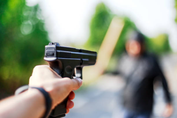 istock Person pointing a gun at the attacker. Auto defense concept. 1047434456