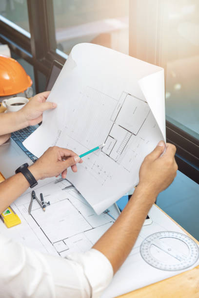 istock Engineer and Architect concept, Engineer Architects and real estate agent office team working with blueprints 1047436914
