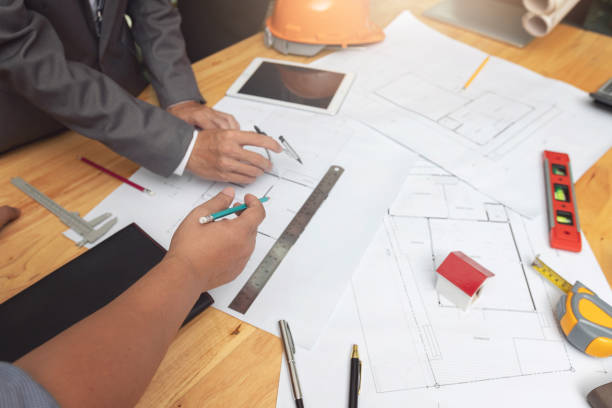 istock Engineer and Architect concept, Engineer Architects and real estate agent office team working with blueprints 1047436974