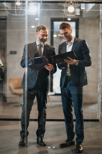 istock Happy businessmen cooperating while going through new data in the office. 1047440822