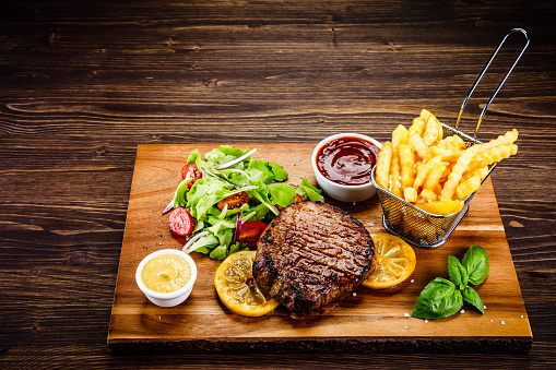 Grilled steak with french fries and vegetable salad