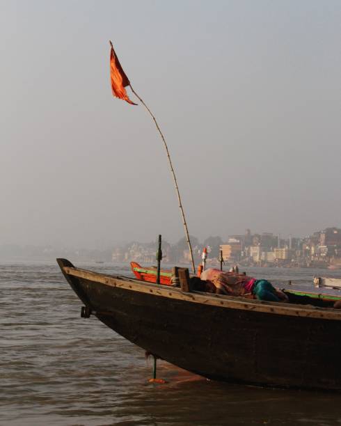 istock Young boy sleeps on boat on the river Ganges, Varanasi 1047455540
