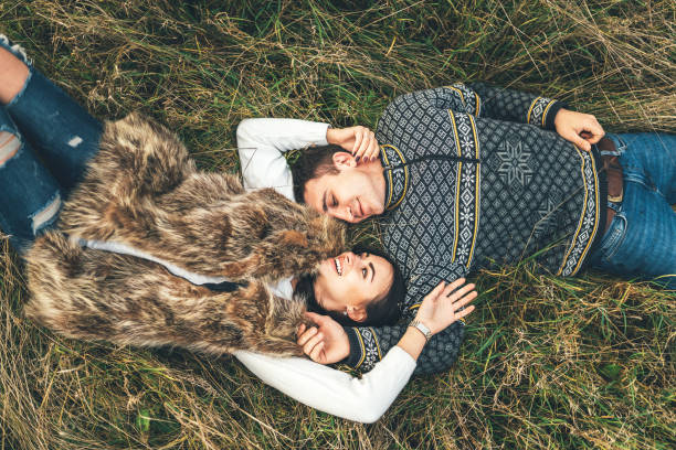 Up view of pretty couple lying in the grass