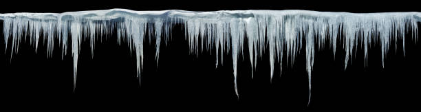 Icicles on an black background Icicles on an black background, isolated object. Panoramic photo. icicle photos stock pictures, royalty-free photos & images