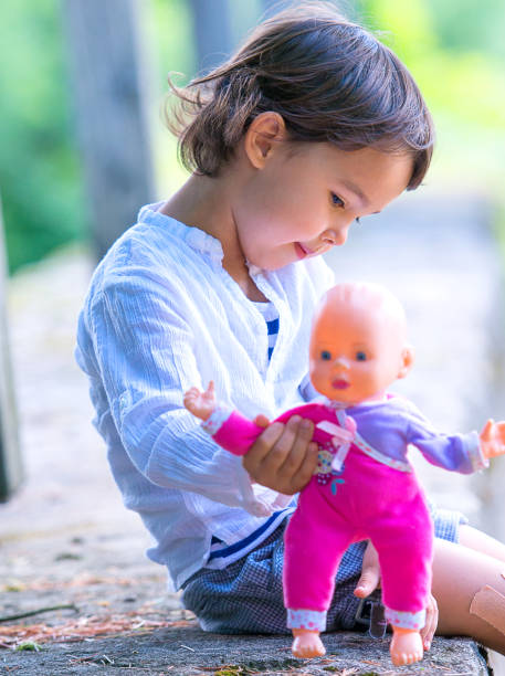 istock Cute little girl holding her doll 1047456898
