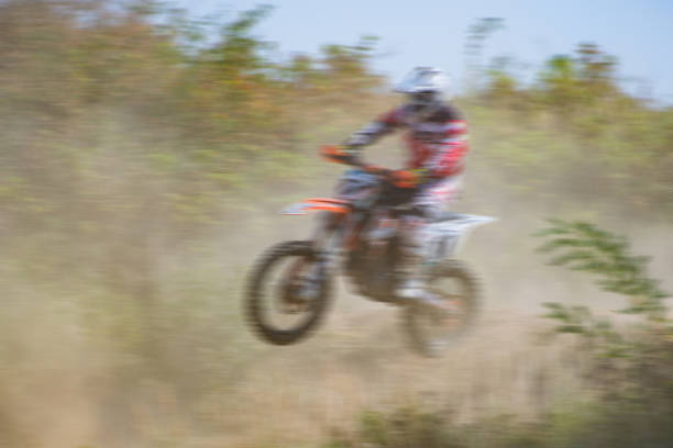 Blurry image of motorcycle riders during motocross race
